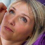 attractive blond woman having threading hair removal procedure